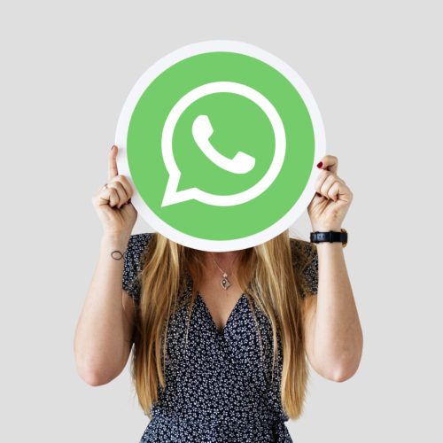 Woman showing a WhatsApp Messenger icon